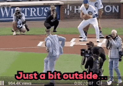 Man In Suit Throwing Baseball Just Outside GIF