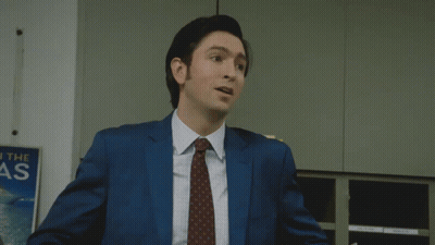 Man In Suit Thumbs Up In Front Of Reach The As Sign GIF