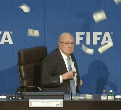 Man In Suit Tie At Desk FIFA Sign GIF