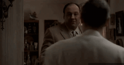 Man In Suit Touching Another's Neck GIF