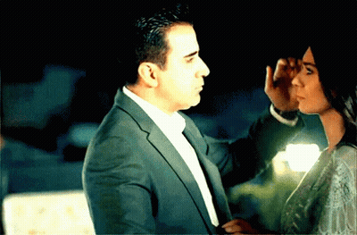 Man In Suit Touching Woman's Face GIF