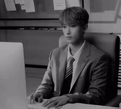 Man in Suit Typing on Keyboard