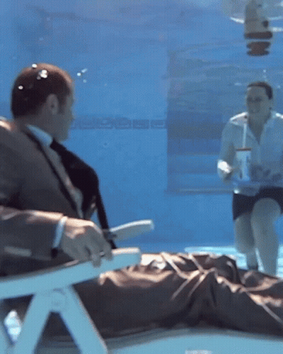 Man In Suit Underwater With Woman On Floor GIF