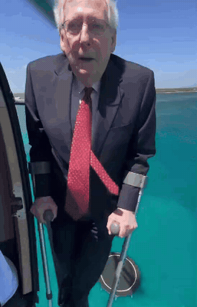 Man In Suit Using Crutches To Get Out Of Vehicle GIF