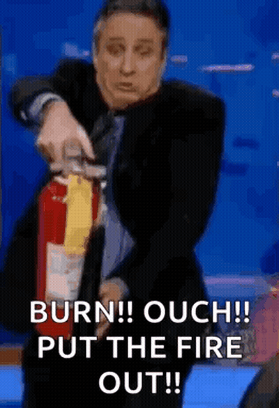Man In Suit Using Fire Extinguisher GIF