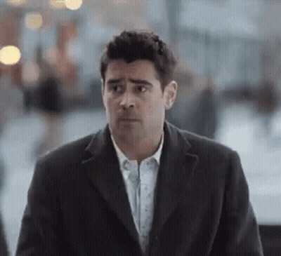 Man In Suit Walking And Looking At Camera GIF