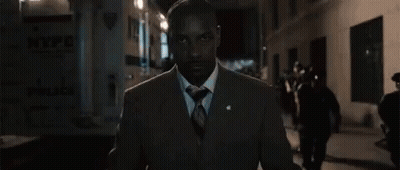 Man In Suit Walking City Street At Night GIF