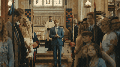 Man In Suit Walking Down Church Aisle With Sign 905 GIF