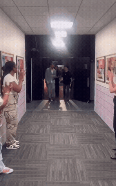 Man In Suit Walking Down Hallway People Clapping GIF