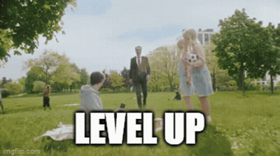 Man In Suit Walking In Park With Woman Holding Soccer Ball Level Up GIF