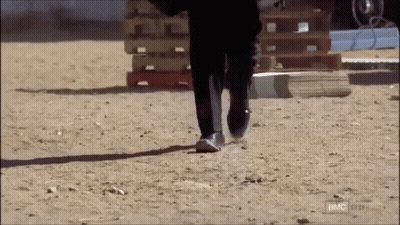 Man In Suit Walking On Dirt Road With BMC GIF
