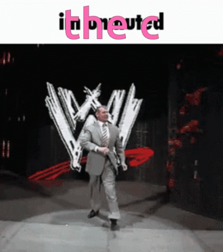Man In Suit Walking On Stage In Front Of WW Logo GIF