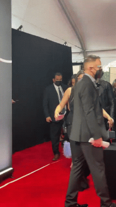 Man In Suit Walking Red Carpet With Woman GIF