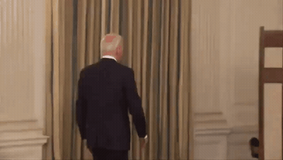 Man In Suit Walking Through Doorway GIF