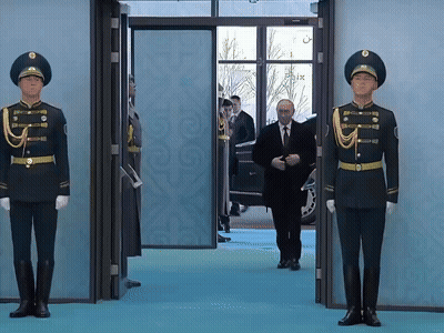 Man In Suit Walking Through Doorway With Two Soldiers GIF