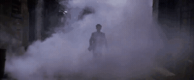 Man In Suit Walking Through Foggy Tunnel GIF