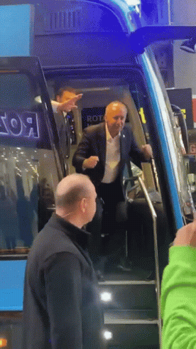 Man In Suit Walking Up Bus Stairs With Rot GIF