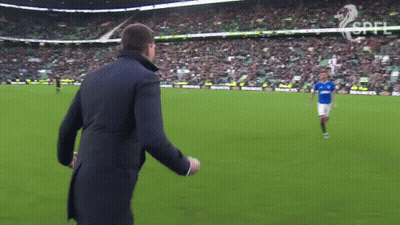 Man In Suit Watching Soccer Player In Blue GIF