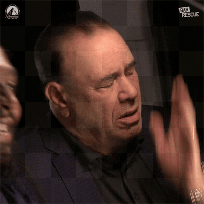 Man In Suit Waving Hands In Front Of Paramount Logo GIF
