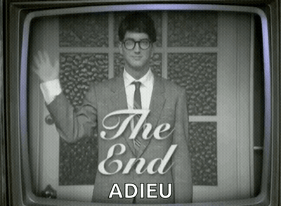 Man In Suit Waving In Front Of The End Screen GIF