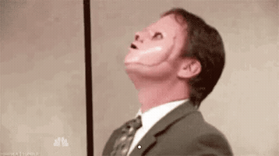 Man In Suit Wearing Fake Face GIF