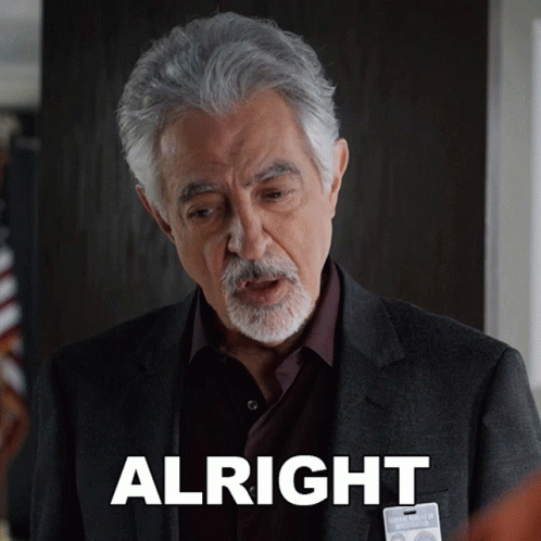 Man In Suit With Alright Badge GIF