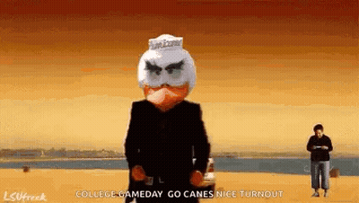 Man In Suit With Angry Bird Mask In Front Of Car GIF