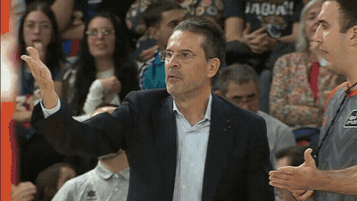 Man In Suit With Aqua Shirt In Front Of Crowd GIF