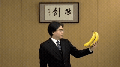 Man In Suit With Banana And Chinese Writing GIF