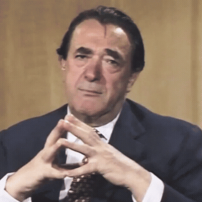 Man In Suit With Folded Hands GIF