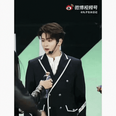 Man In Suit With Headset Microphone Next To Woman GIF