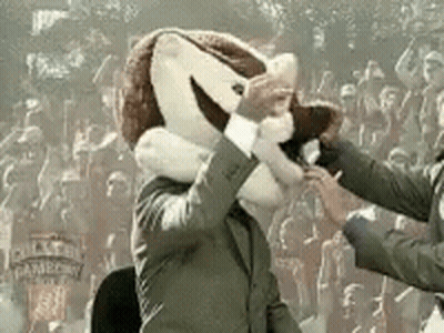 Man In Suit With Mascot On Head Shaking Hands GIF
