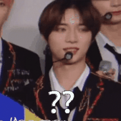 Man In Suit With Microphone And Question Mark GIF