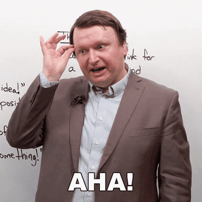 Man In Suit With Microphone Says Aha GIF