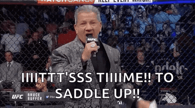 Man In Suit With Microphone Says To Saddle Up GIF