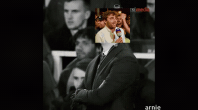 Man In Suit With Picture Behind Saying Annie GIF