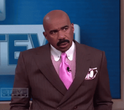 Man In Suit With Pink Tie And Steve Harvey Logo GIF