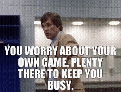 Man In Suit With Sign You Worry About Your Own Game GIF