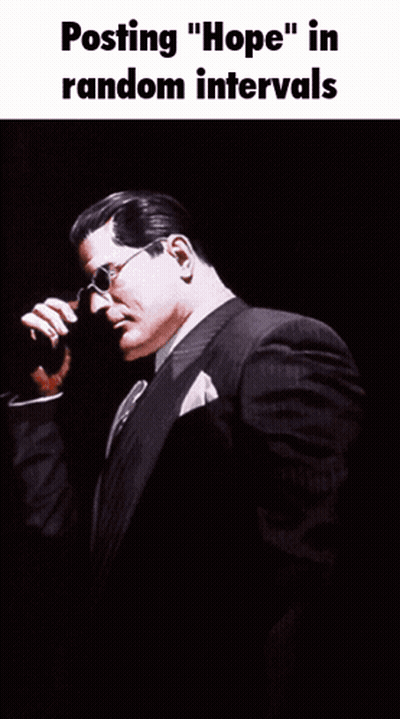 Man In Suit With Superman Emblem GIF