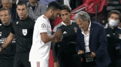 Man In Suit With Tablet Watching Soccer Handshake GIF