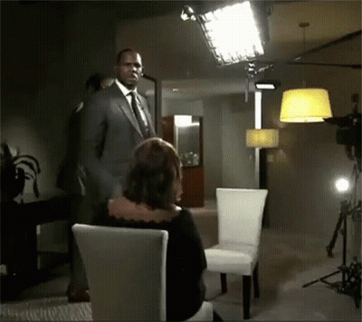 Man In Suit With Tie Before Woman In Chair GIF
