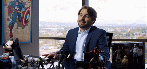 Man In Suit With Toys And Captain America Poster GIF