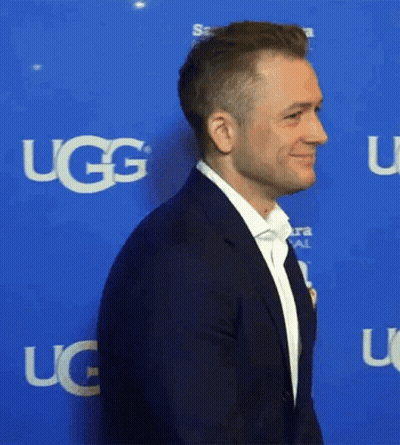 Man In Suit With UGG On Blue Background GIF