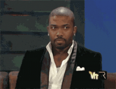 Man In Suit With VTR Logo On Couch GIF