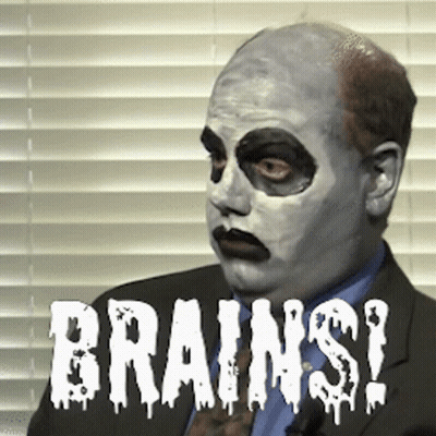 Man In Suit With White Face Saying Brains GIF