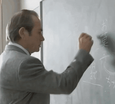 Man In Suit Writing Chinese Characters On Whiteboard GIF