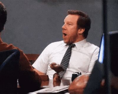 Man In Suit Yawning At Table GIF