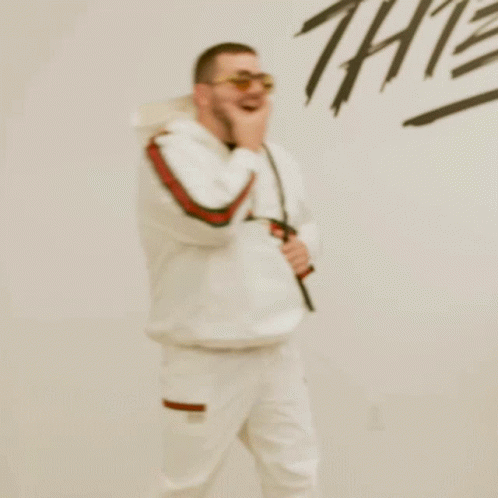 Man In Sunglasses And Backpack In Front Of Thieves Wall GIF