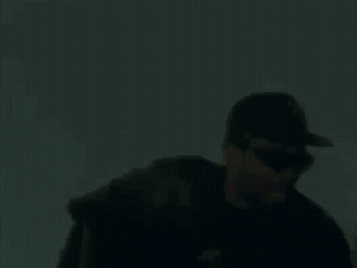 Man In Sunglasses And Baseball Cap Holding Beer Bottle GIF