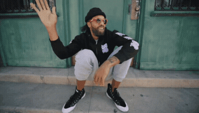 Man In Sunglasses And Beanie Sitting By Door GIF